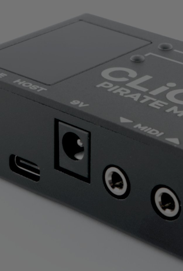 Close-up of the CLiCK v2's black aluminium enclosure and its USB, 9V and MIDI jacks